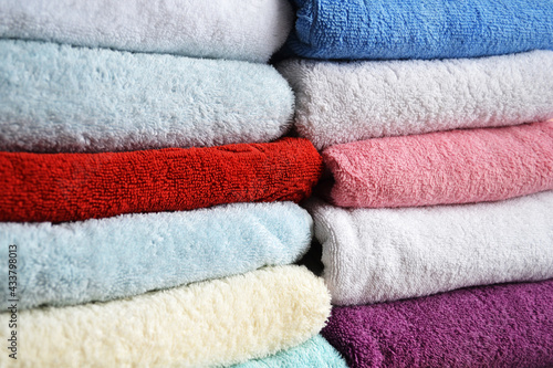 Multi-colored cotton terry towels are stacked