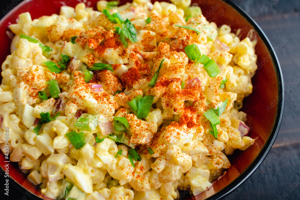 Deviled Egg Pasta Salad in a Serving Bowl: A large bowl of macaroni salad made with hard-boiled eggs Deviled Egg Pasta Salad in a Serving Bowl: A large bowl of macaroni salad made with hard-boiled eggs