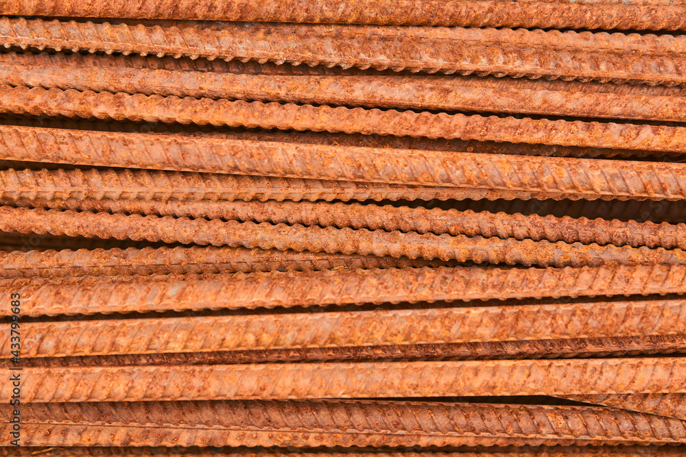 background - pieces of rusty rebar piled in a heap close-up background - pieces of rusty rebar piled in a heap close-up