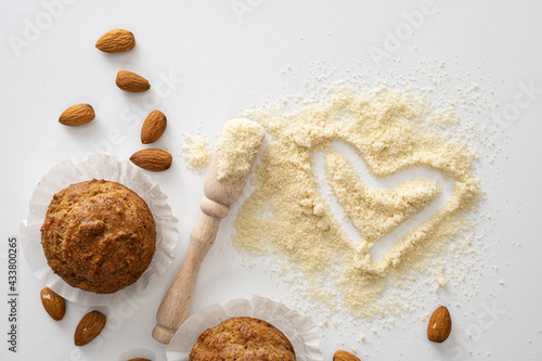 gluten free baked goods, muffins on almond flour with nuts on a white background, love heart symbol, keto food, top view