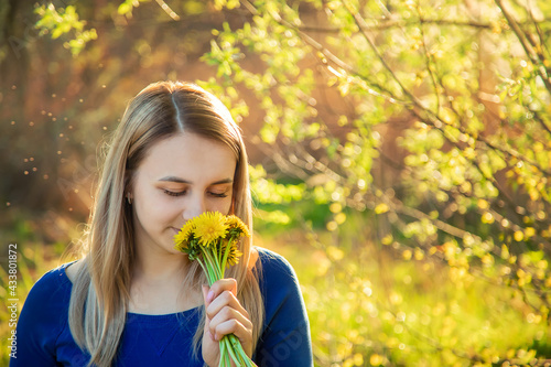 The girl is allergic to flowers in the field. Selective focus
