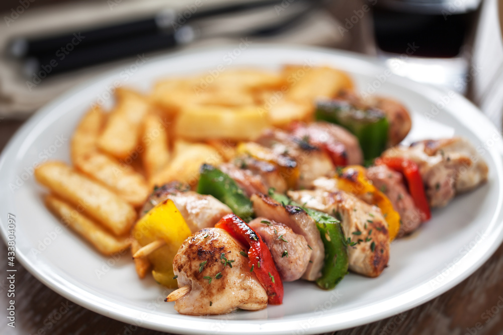 Chicken skewers with fries. High quality photo. Chicken skewers with fries. High quality photo.