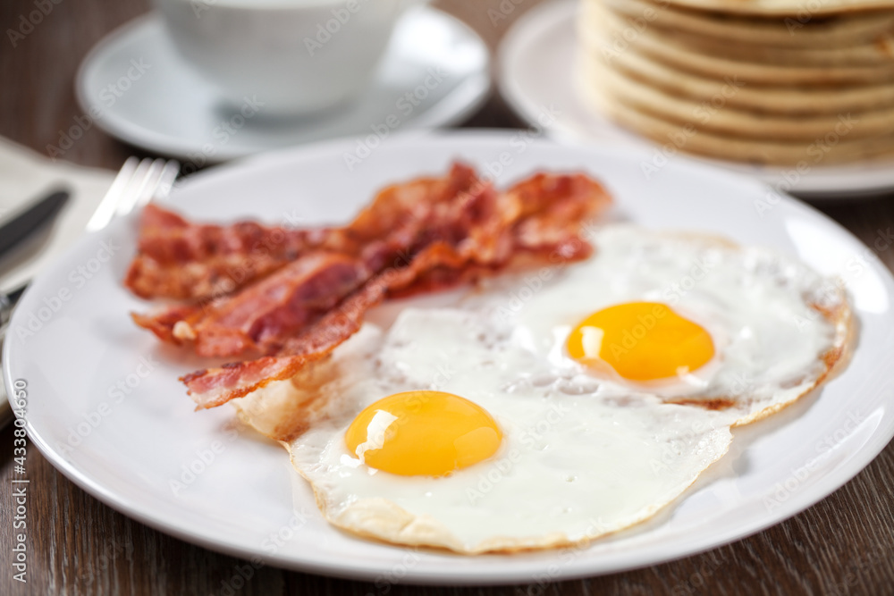 Fried Eggs with Pancakes and Bacon. High quality photo. Fried Eggs with Pancakes and Bacon. High quality photo.