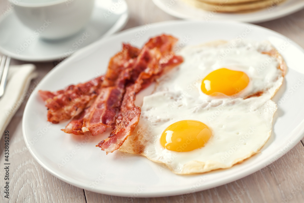 Fried Eggs with Pancakes and Bacon. High quality photo. Fried Eggs with Pancakes and Bacon. High quality photo.