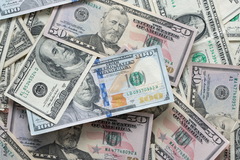 Dollar banknotes spread out. One dollar to one hundred dollar banknotes. Background with US dollar banknotes. Cash 100 and fifty dollar bills Dollar banknotes spread out. One dollar to one hundred dollar banknotes. Background with US dollar banknotes. Cash 100 and fifty dollar bills