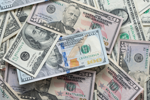 Dollar banknotes spread out. One dollar to one hundred dollar banknotes. Background with US dollar banknotes. Cash 100 and fifty dollar bills