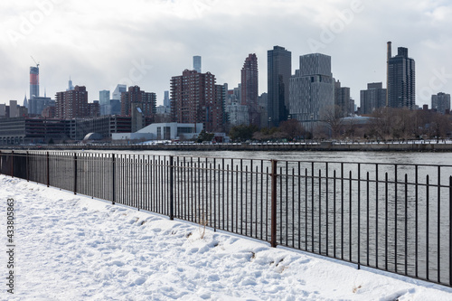 Rainey Park in Astoria Queens Covered in Snow during Winter along the East River with the New York City Skyline