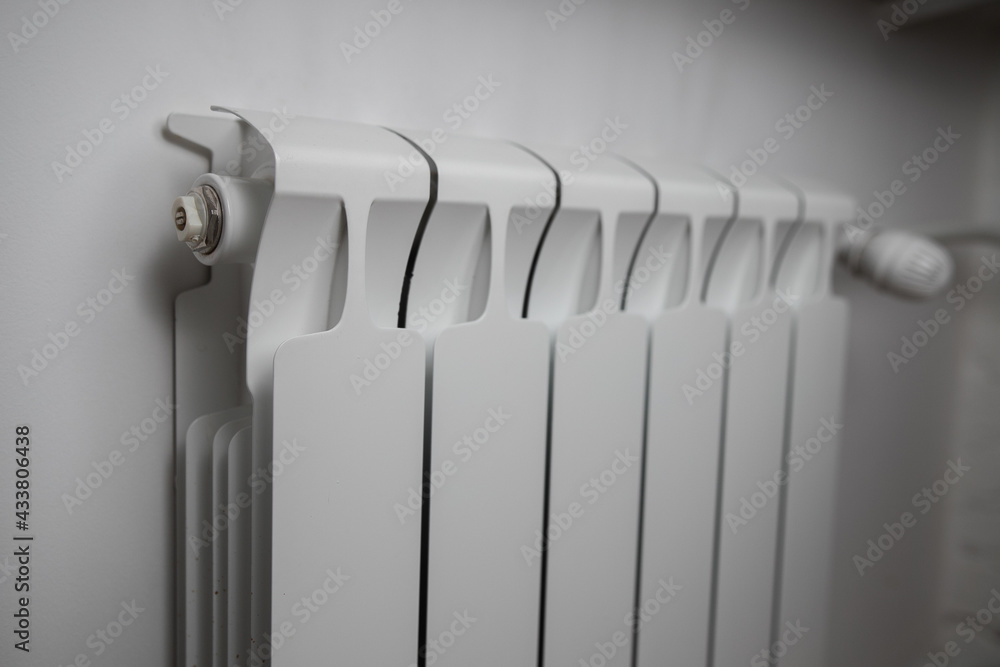 Panel heating with heat regulator. White radiator