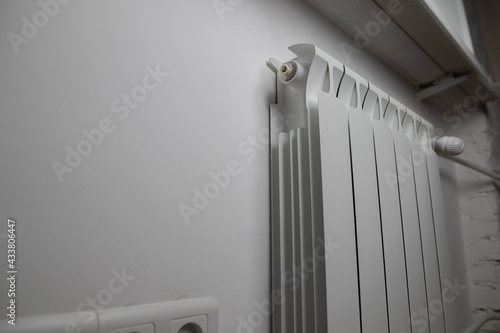 Panel heating with heat regulator. White radiator