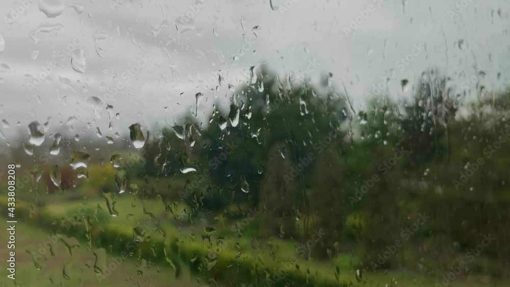 raindrops on the window. large raindrops fall on the window glass and flow down raindrops on the window. large raindrops fall on the window glass and flow down