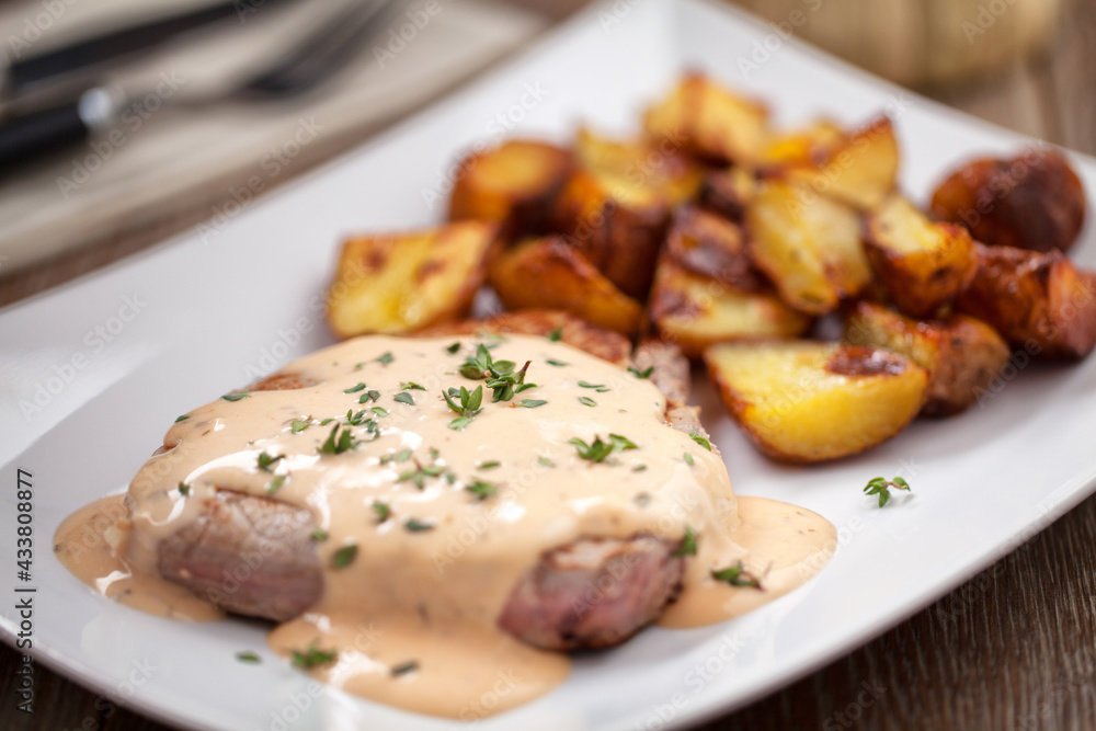 Fillet of beef with potatoes and asparagus on a plate. Fillet of beef with potatoes and asparagus on a plate.