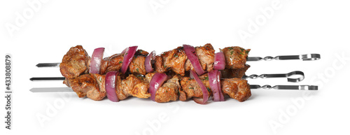 Metal skewers with delicious meat and onion on white background