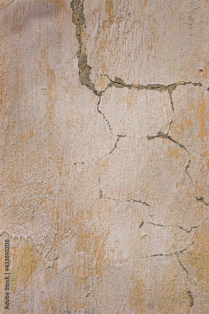 Fototapeta premium Gray plastered concrete wall with cracks. Industrial building. Grunge. Is an excellent choice for your design and texture background. Space for text.
