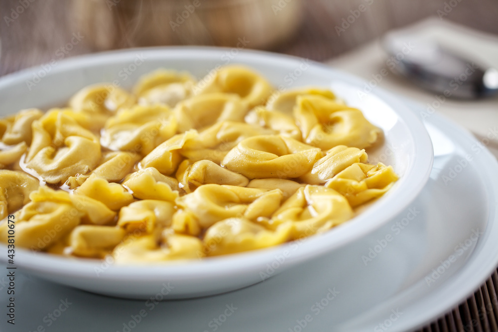 Italian Tortellini In broth on a plate. Italian Tortellini In broth on a plate.