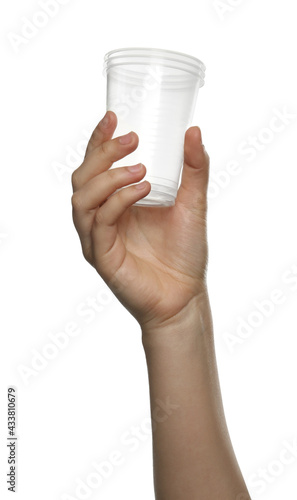 Woman holding plastic cups on white background, closeup