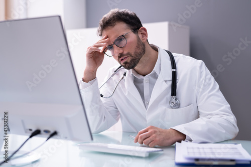 Frustrated Overworked Doctor In Hospital Looking