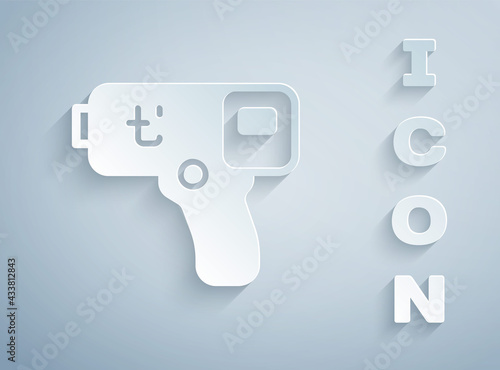 Paper cut Digital contactless thermometer with infrared light icon isolated on grey background. Paper art style. Vector