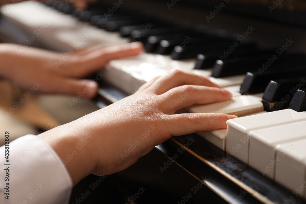 Fototapeta premium Little child playing piano, closeup. Music lesson