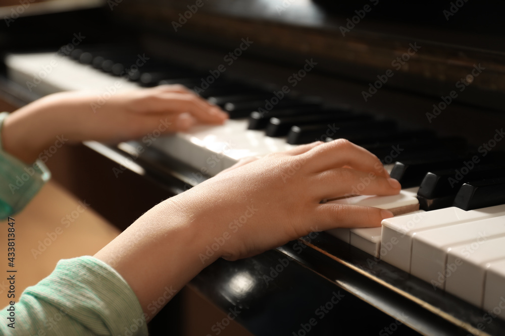 Obraz premium Little child playing piano, closeup. Music lesson