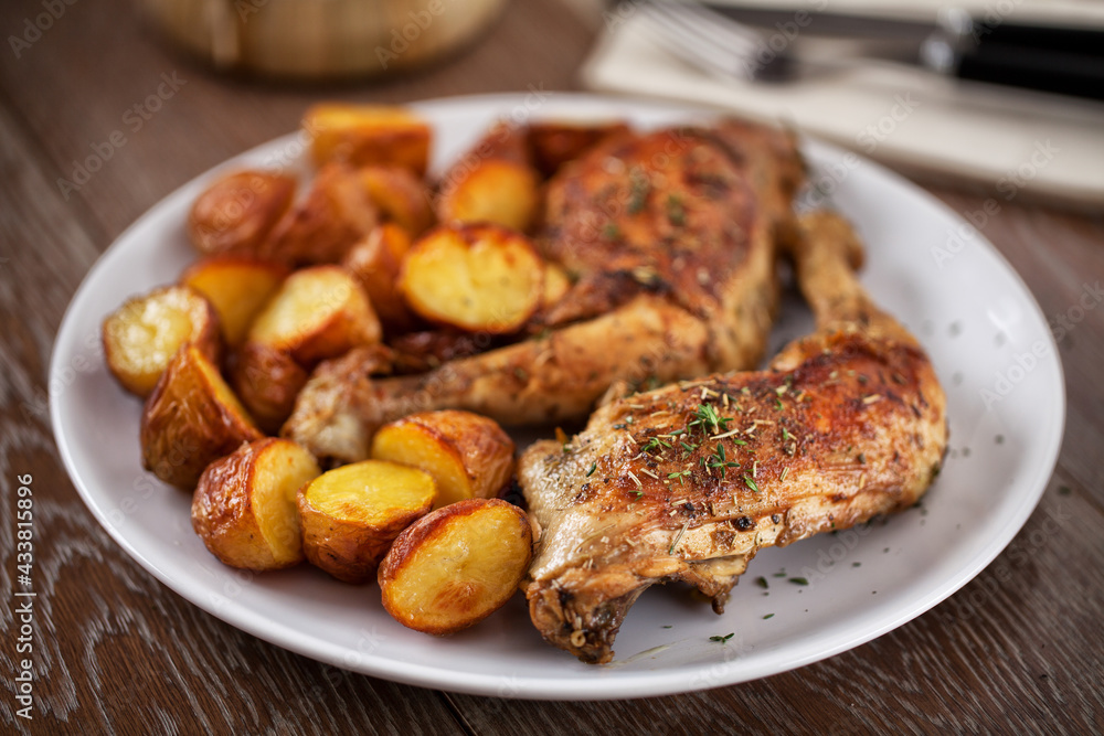 Roast Chicken Thighs with Potatoes on a Plate Roast Chicken Thighs with Potatoes on a Plate