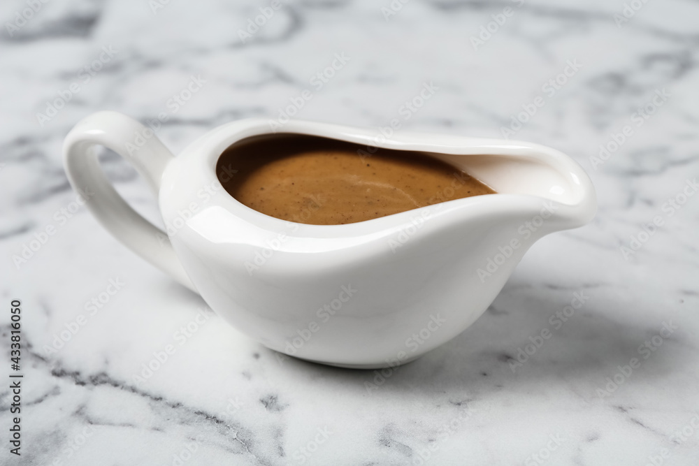 Delicious turkey gravy in sauce boat on white marble table Stock Photo |  Adobe Stock