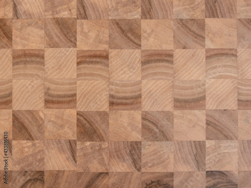 Background. The checkered wooden board made from large squares of walnut.
