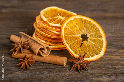 Juicy oranges and spices on a wooden background