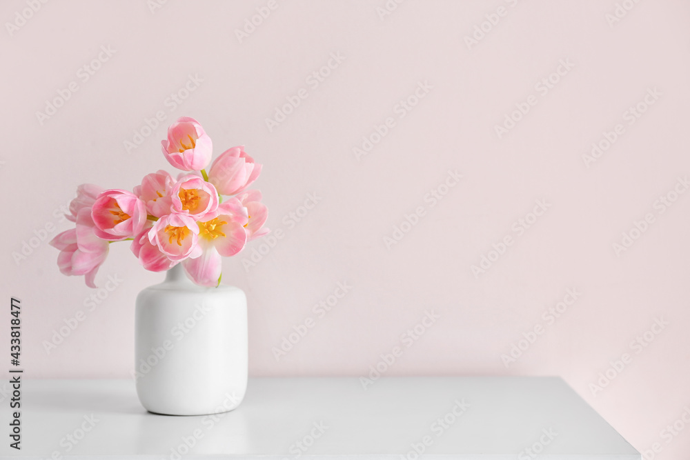 Vase with beautiful tulip flowers on table