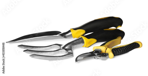 Trowel, pruning shears and pitchfork on white background. Gardening tools