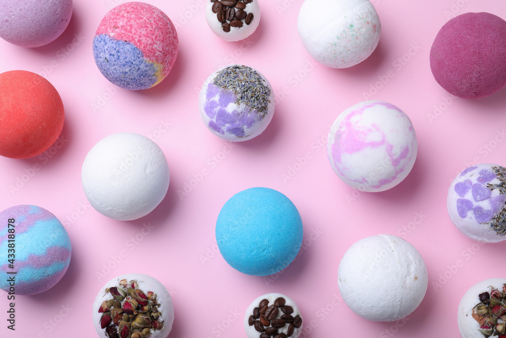 Colorful bath bombs on pink background, flat lay Colorful bath bombs on pink background, flat lay