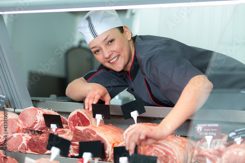 female butcher posing and smiling