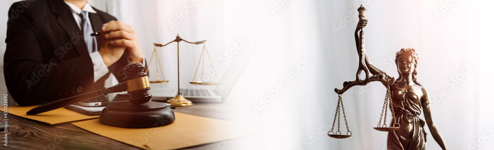 Business and lawyers discussing contract papers with brass scale on desk in office. Law, legal services, advice, justice and law concept picture with film grain effect Business and lawyers discussing contract papers with brass scale on desk in office. Law, legal services, advice, justice and law concept picture with film grain effect