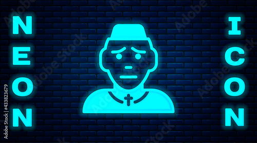 Glowing neon Priest icon isolated on brick wall background. Vector
