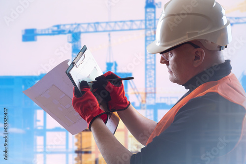 Builder worker draws archit...