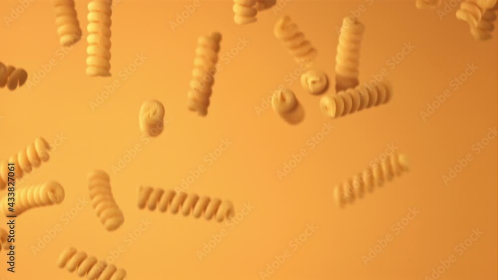 Super slow motion of the dry fusilli pasta drops. On an orange background. Filmed on a high-speed camera at 1000 fps. High quality FullHD footage Super slow motion of the dry fusilli pasta drops. On an orange background. Filmed on a high-speed camera at 1000 fps. High quality FullHD footage