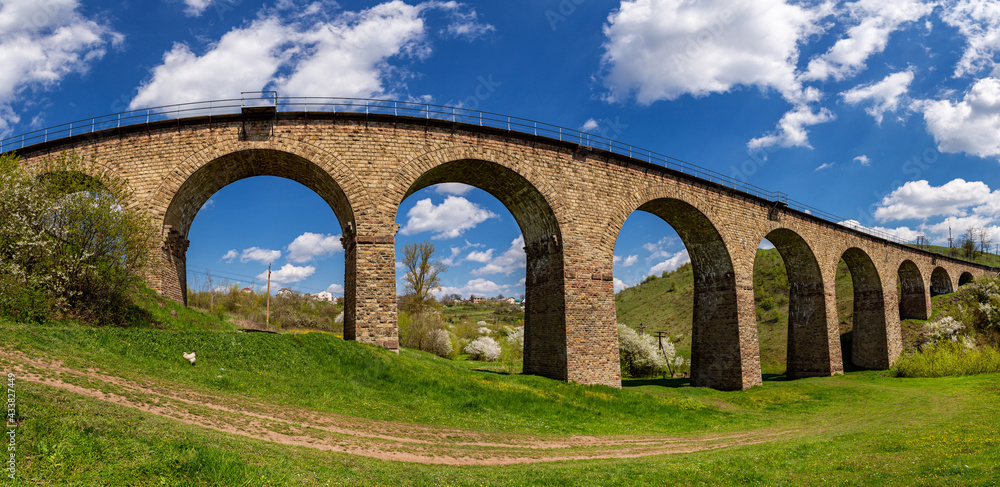 Old railway stone viaduct in the spring in sunny day.