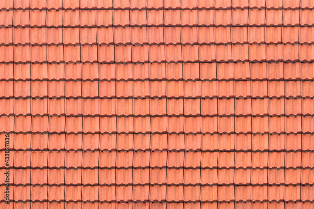 Old tile on the roof of orange-gray color as a background, texture, pattern. Old tile on the roof of orange-gray color as a background, texture, pattern.