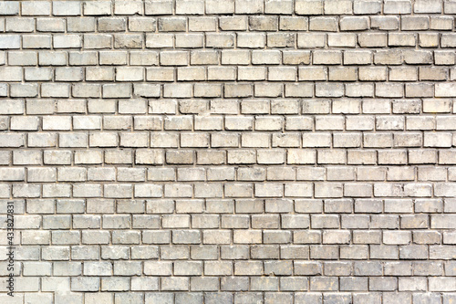 Beautifully and evenly laid gray brick wall as a background, texture, pattern.
