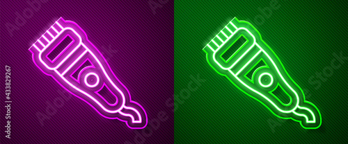 Glowing neon line Electrical hair clipper or shaver icon isolated on purple and green background. Barbershop symbol. Vector