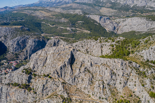 Dalmatian coastline mountains near Omis. Sunny day with blue sky. August 2020. Aerial drone shot.