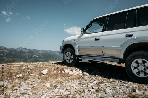 Landscape with white off road car, Traveling by auto, adventure in wildlife, expedition or extreme travel on a SUV automobile.