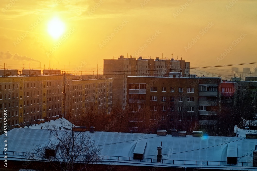 the light of the setting sun over the houses