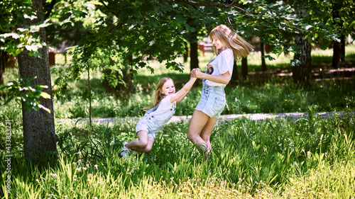 Mother and daughter playing in public park