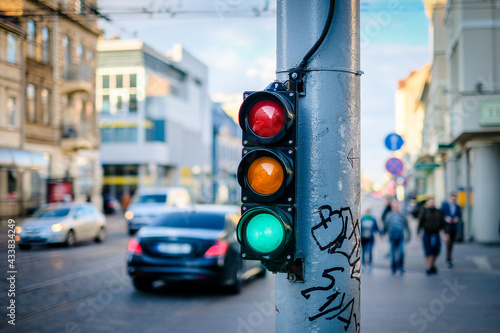 Pedestrian traffic light on the street junction in the city, green light. Selective focus