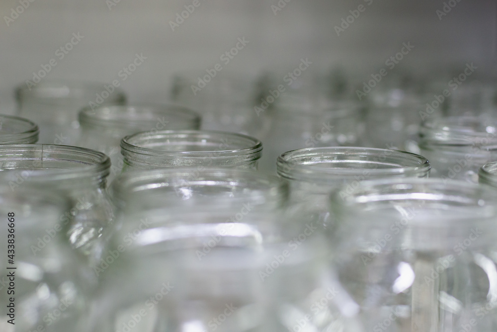 Glass jars without lids on the shelf.