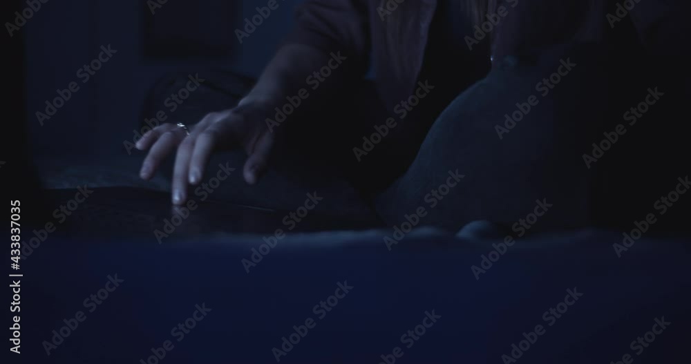 Woman's hand using a laptop's touchpad to browse the internet late hours at home. Slow motion, close up. Woman's hand using a laptop's touchpad to browse the internet late hours at home. Slow motion, close up.