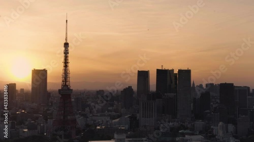 Video of a cityscape depicting the Tokyo tower and Roppongi Hills skyscrapers at sunset in the Daimon district of Tokyo city. photo