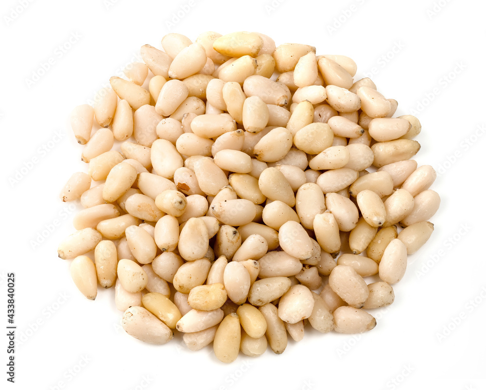 handful of unpeeled pine nuts closeup on white handful of unpeeled pine nuts closeup on white