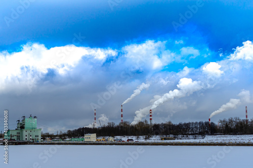 Factory chimneys that emit thick smoke. smoking pipes of harmful chemical production. Copy space for text