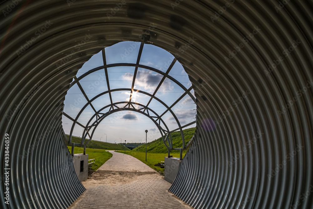 Fototapeta premium round tunnel footpath on blue sky background
